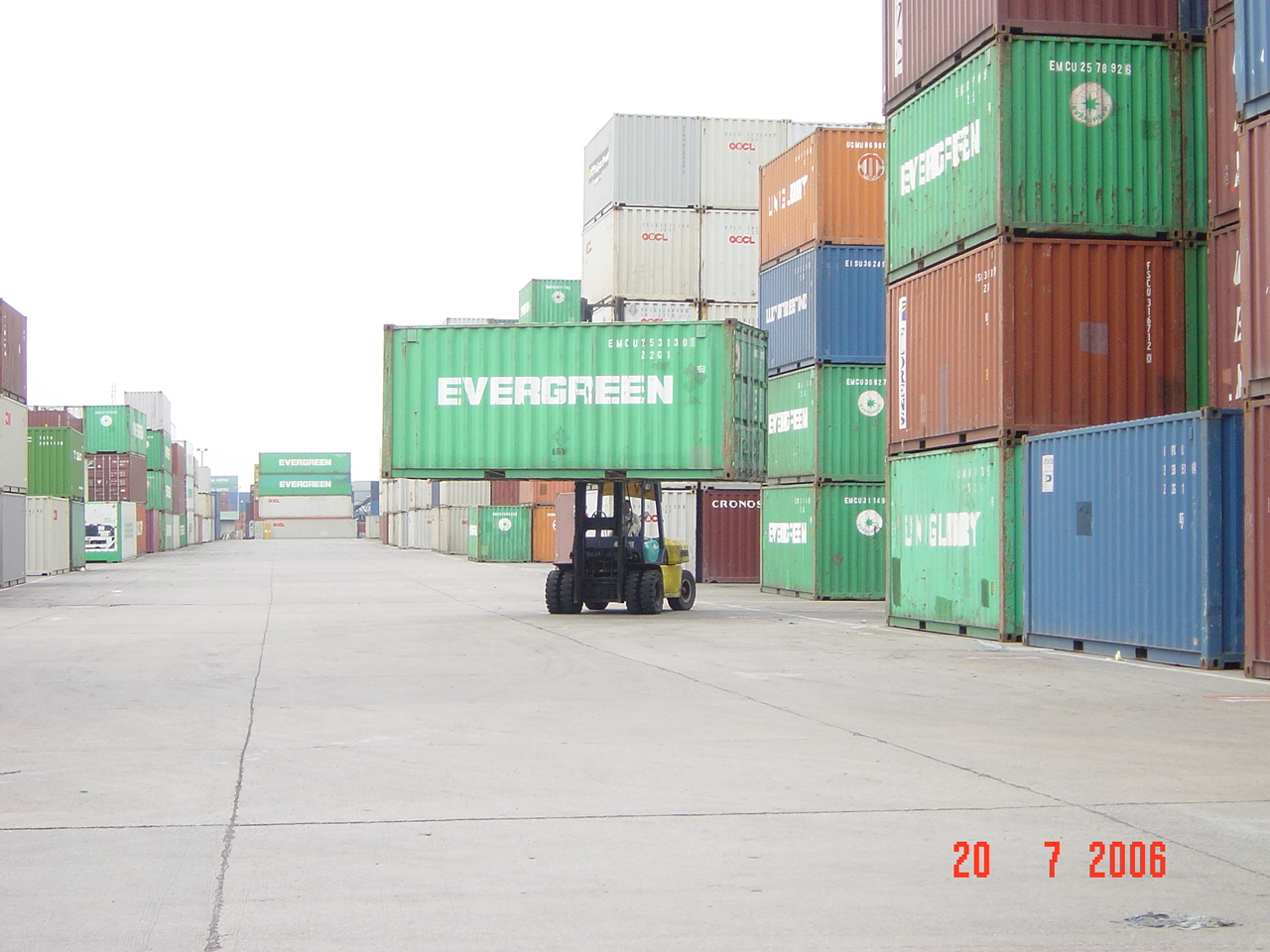A container handler moving a shipping container in a freight yard, photographed on 20 July 2006.